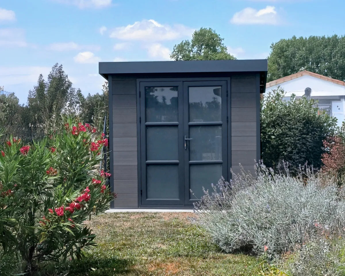 Abri composite gris à porte double vitrée chez un client
